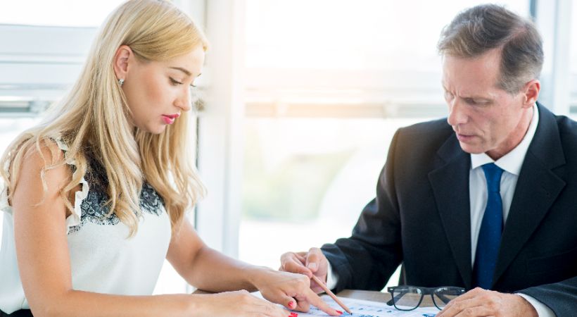 Couple signing prenuptial agreement 