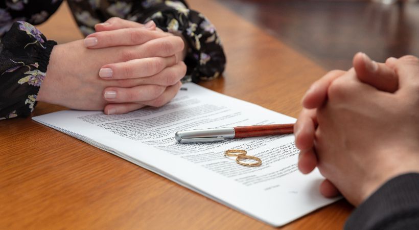 Couple signing prenuptial 