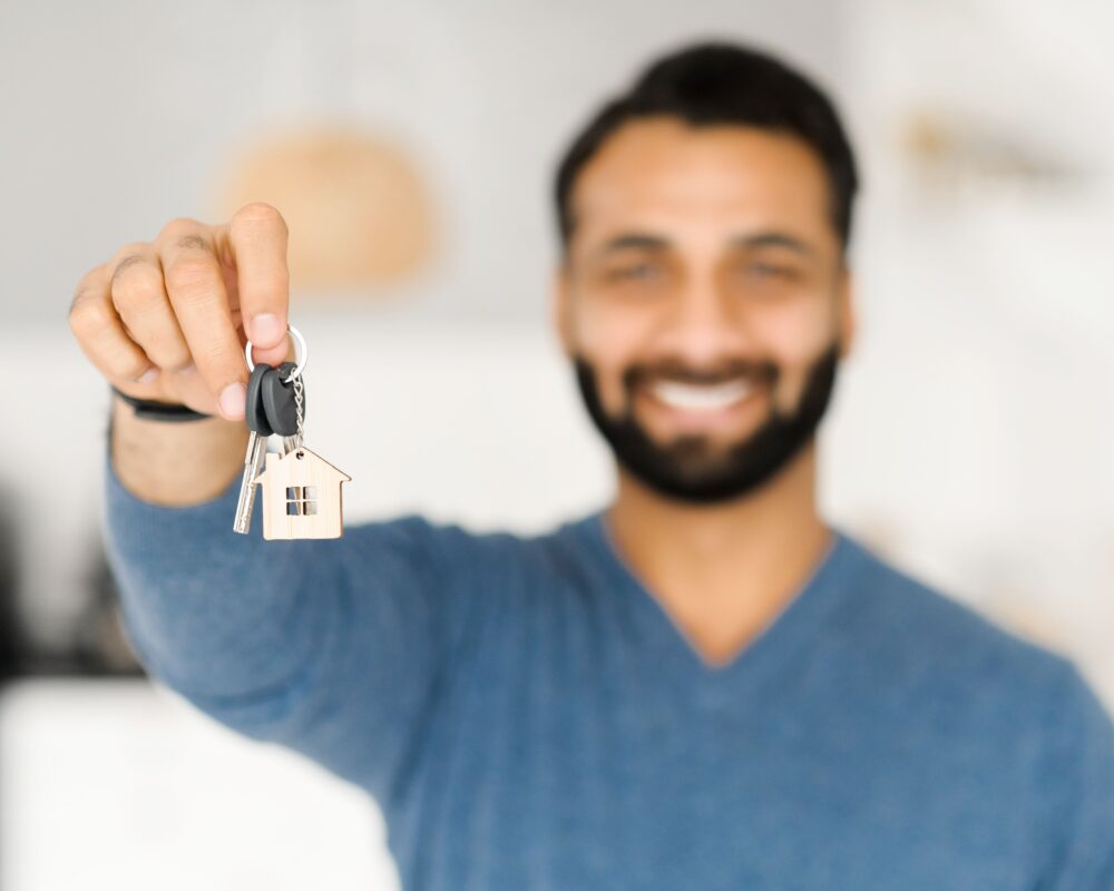 Man holding keys to property
