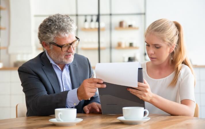Senior solicitor explaining legal documents to a client during a will consultation