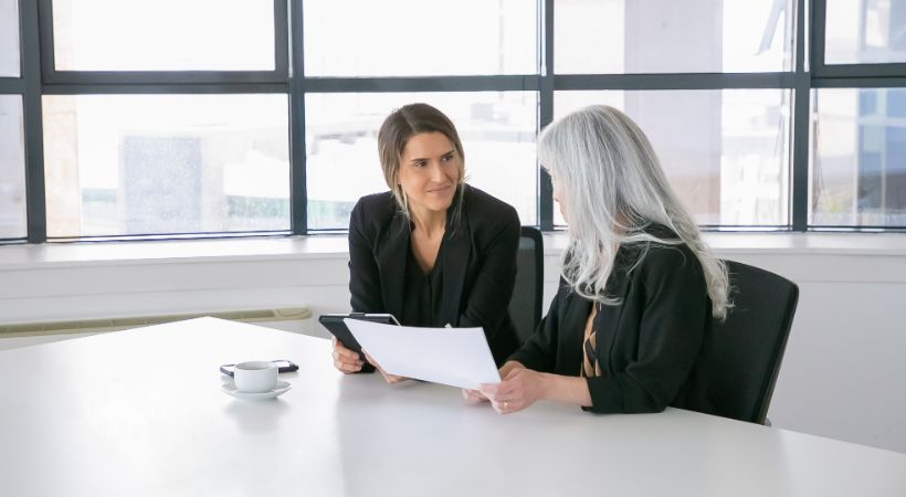 Solicitor and client discussing legal documents in a bright office, illustrating a personal injury consultation