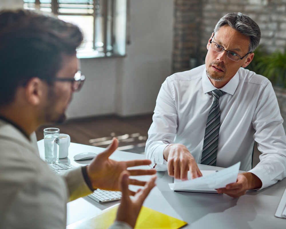A stressed person at work talking to a solicitor