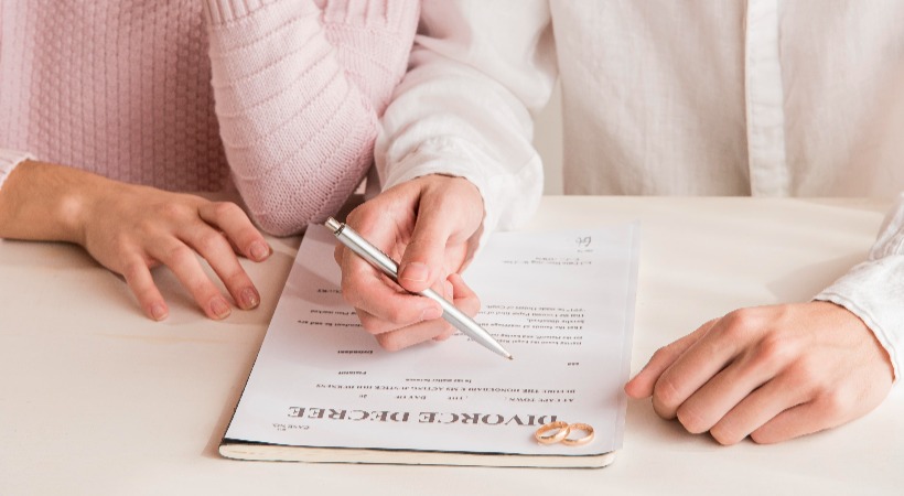 Couple going through the details of a divorce agreement document.