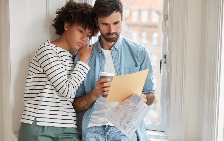 Couple looking through legal agreement document.