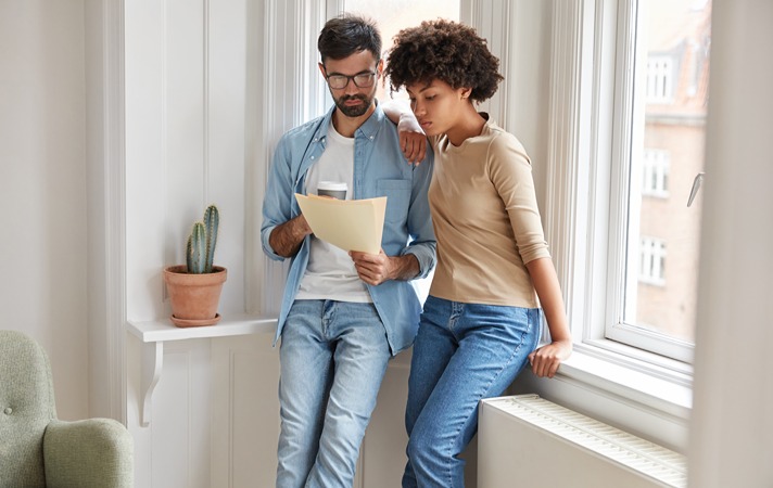 Young couple reviewing document together